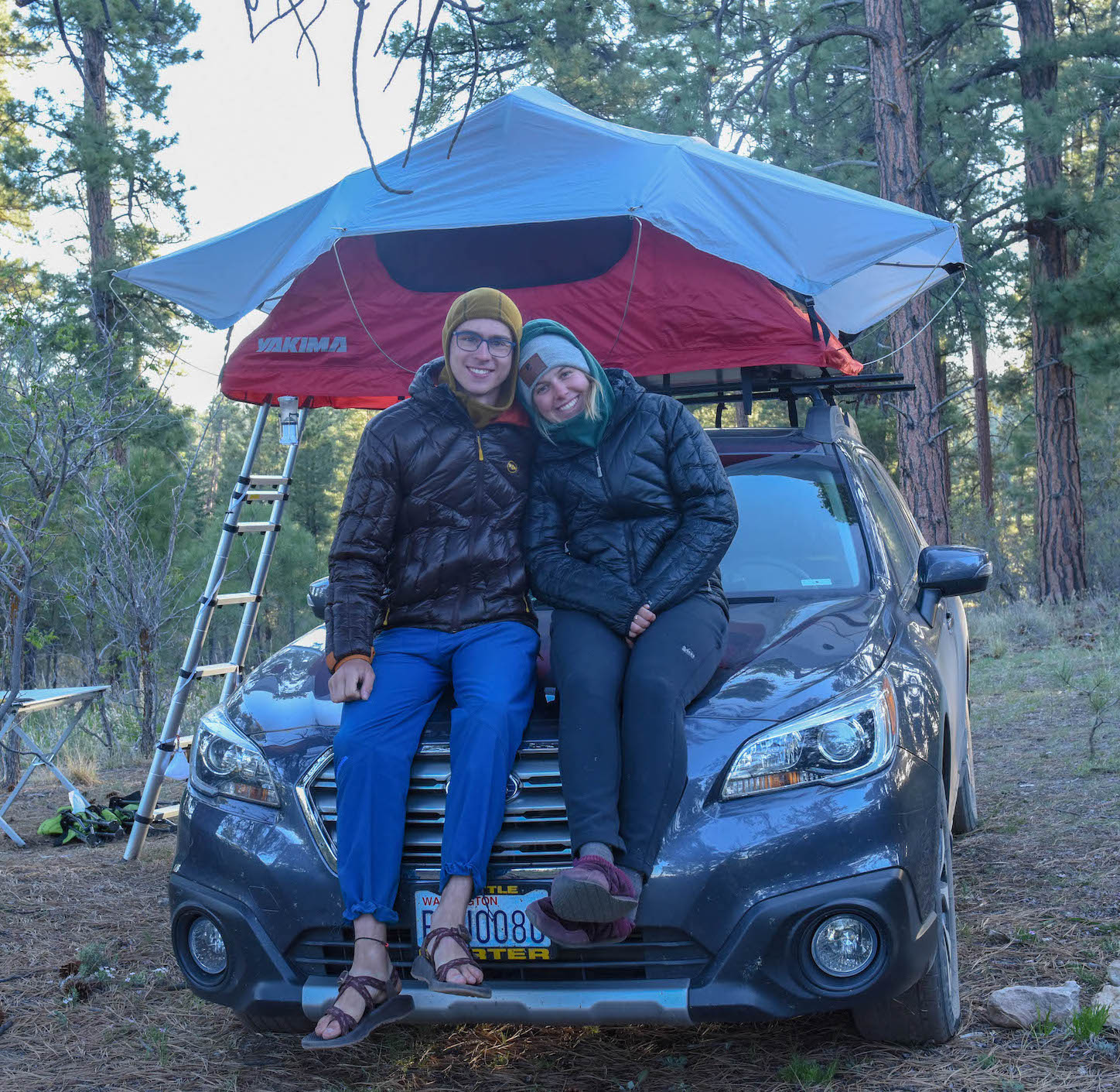 Sophia and Wilson on the hood of the Subaru